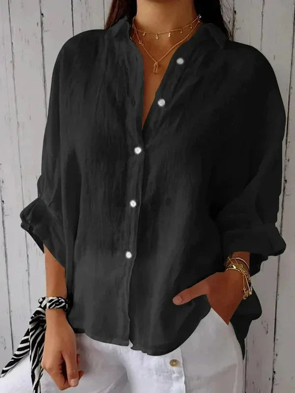 Full-length view of V-neck linen blouse paired with white trousers for summer styling