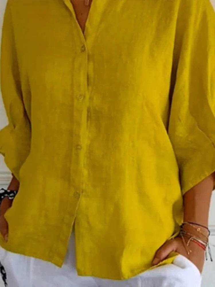 Detail shot of button-front closure and lightweight fabric texture on women's summer top