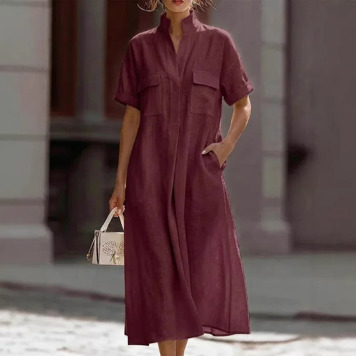Close-up of women's shirt dress chest flap pockets and button-front closure detail